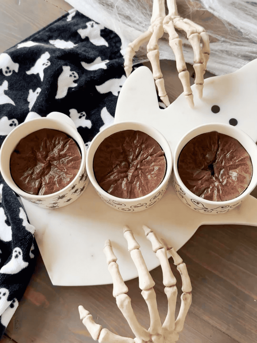 Easy halloween brownies with BOO design on ghost tray. Skeleton hands with ghost towel for added decor.